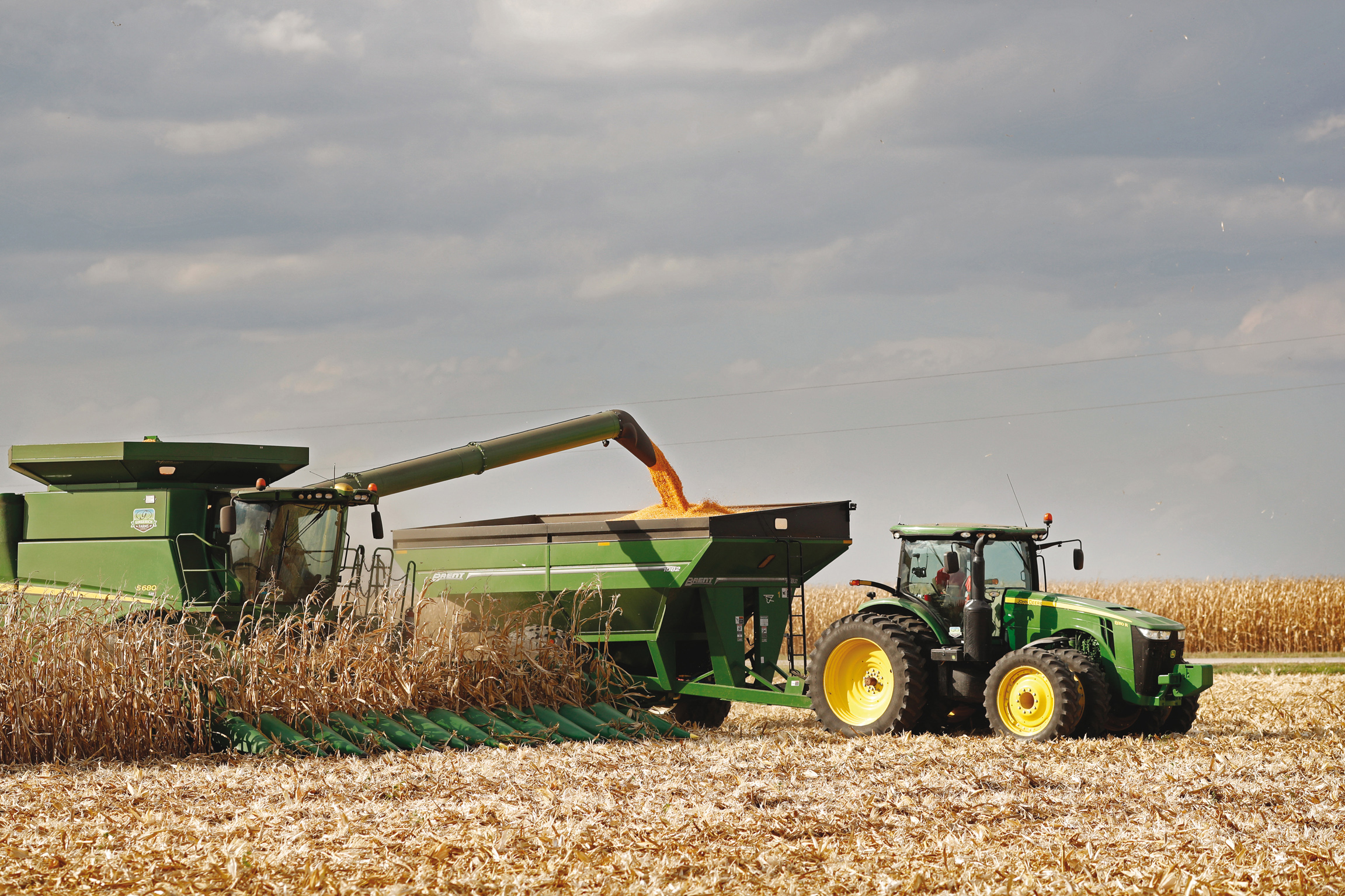 Corn harvest equipment unloading grain