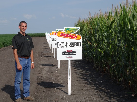 Wade Feuchtenberger standing beside DEKALB plot signs